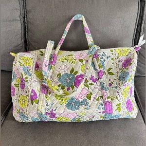 Blue, green and purple floral print duffle bag. 21” long 10” tall